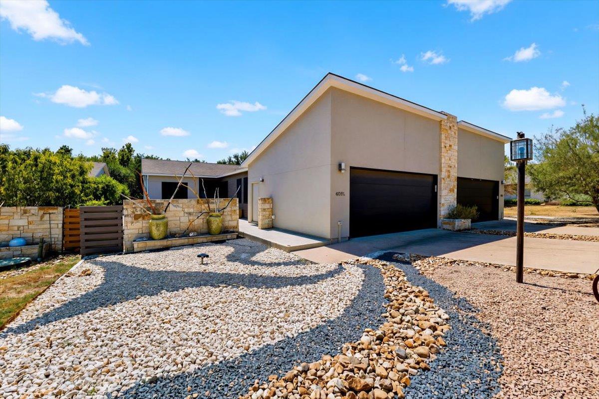 Artfully patterned stone landscaping leads toward