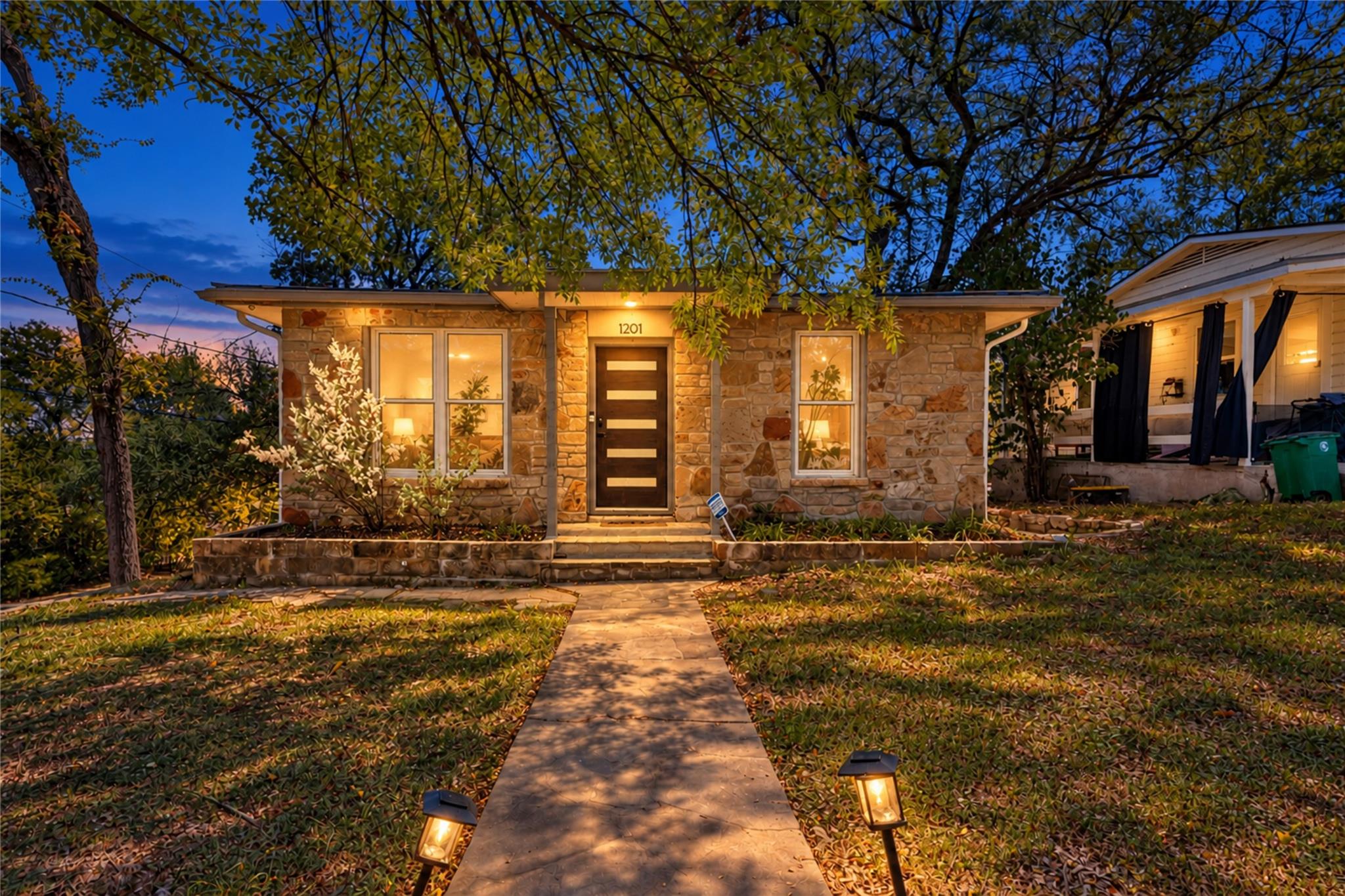 Warm stone masonry paired with a welcoming concre