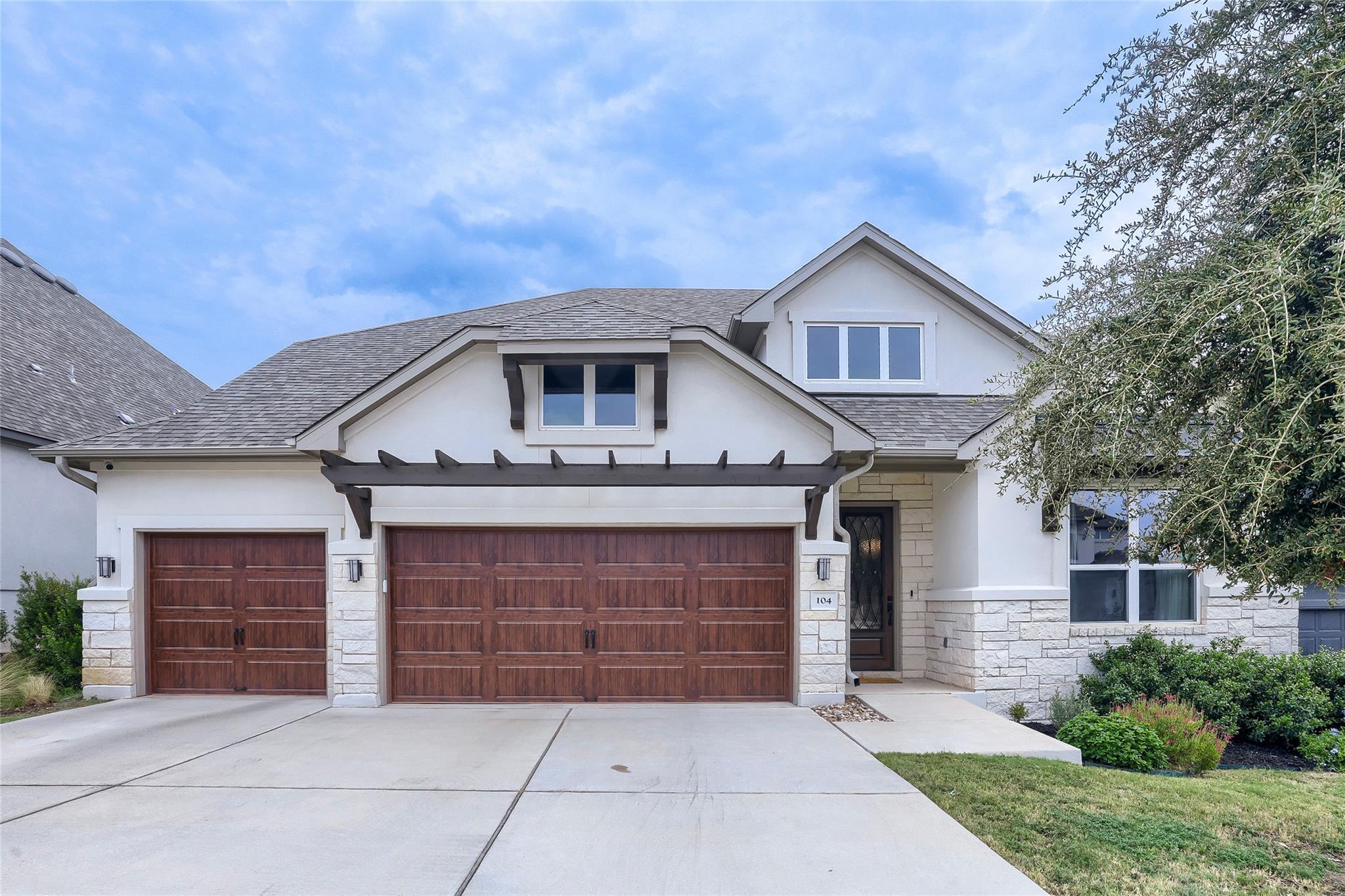 A classic facade combines clean stucco, rustic st
