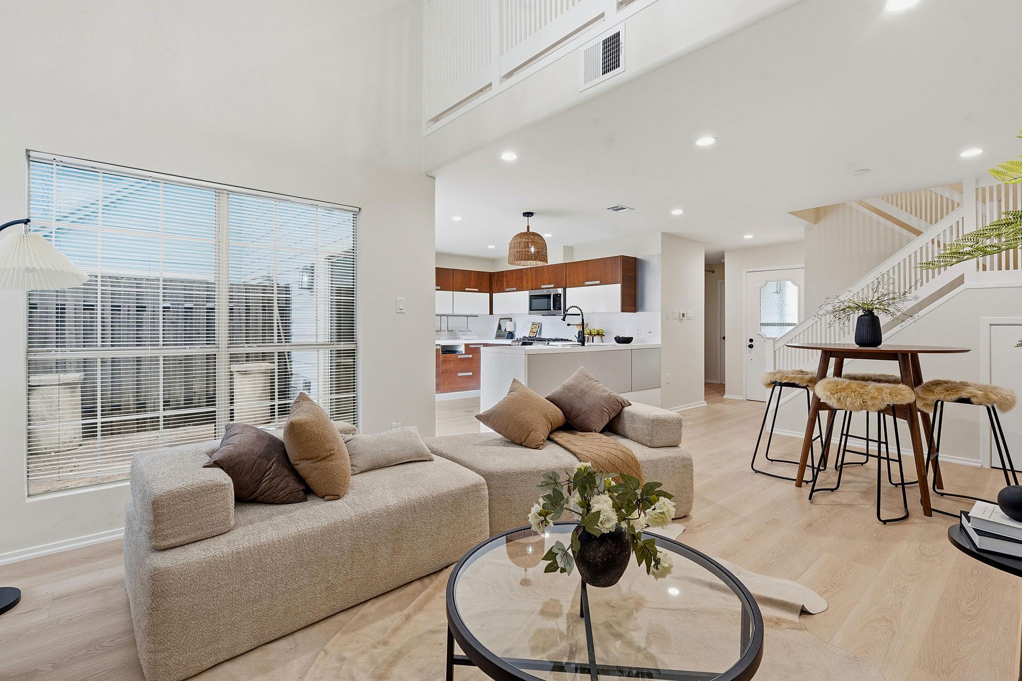 Soaring high ceilings and tall windows anchor thi