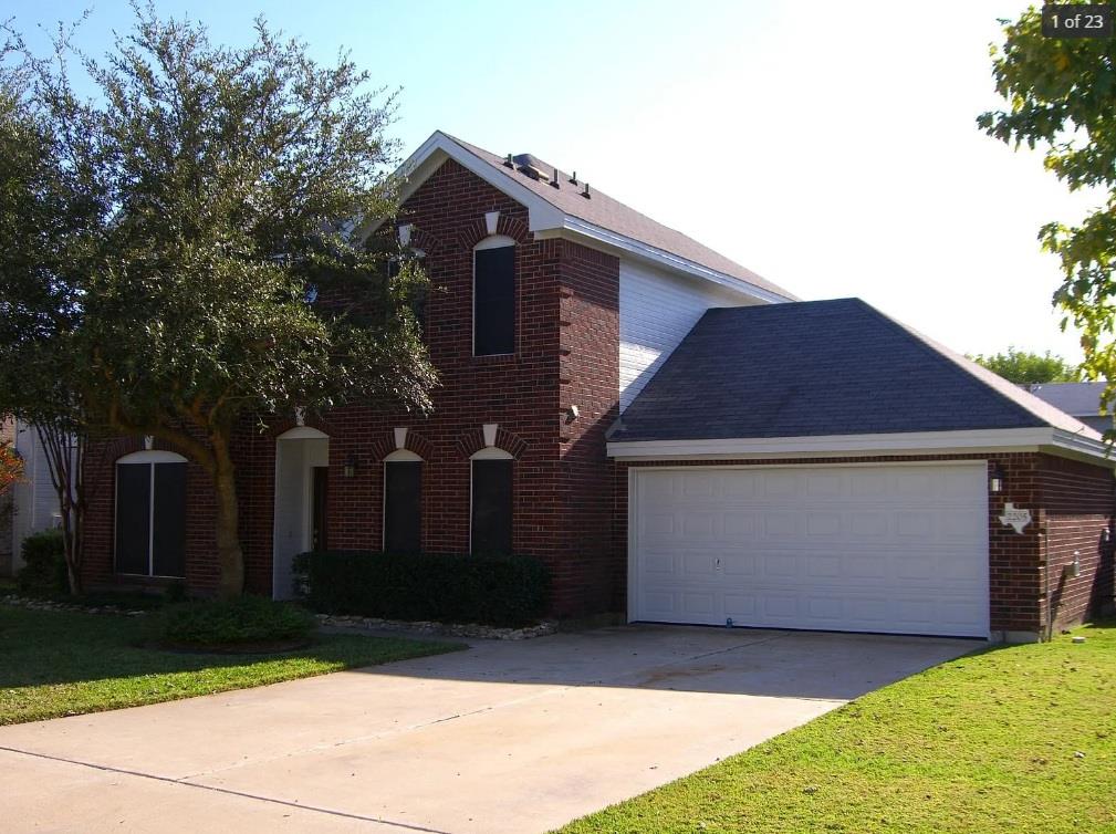 Classic brick exterior and an attached garage est