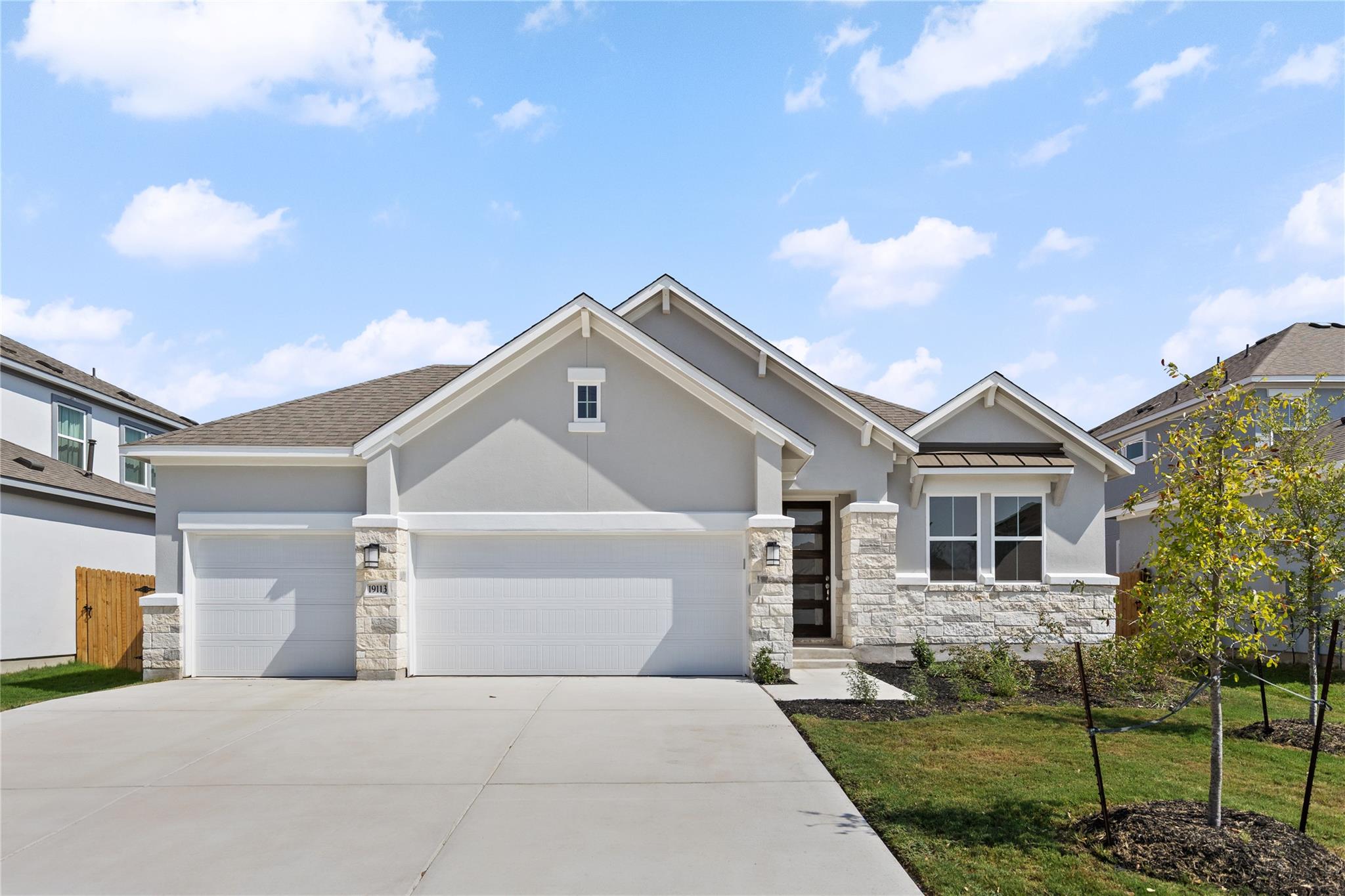 A spacious driveway leads to this modern single-f
