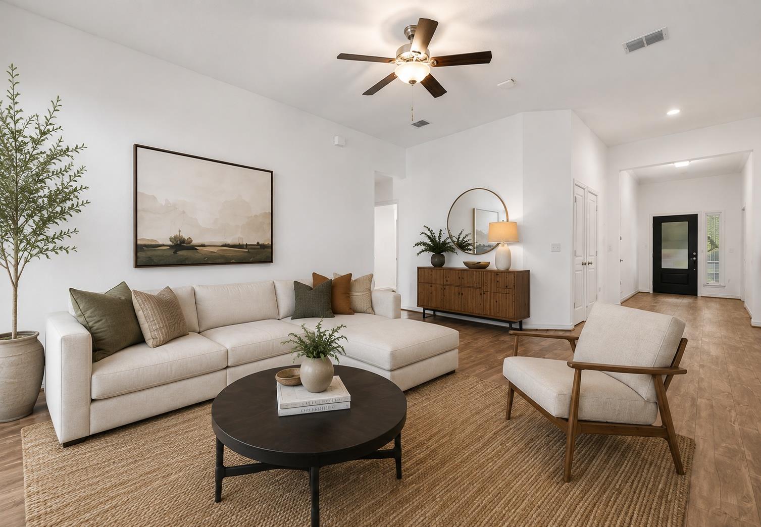 An open living room features recessed lighting an