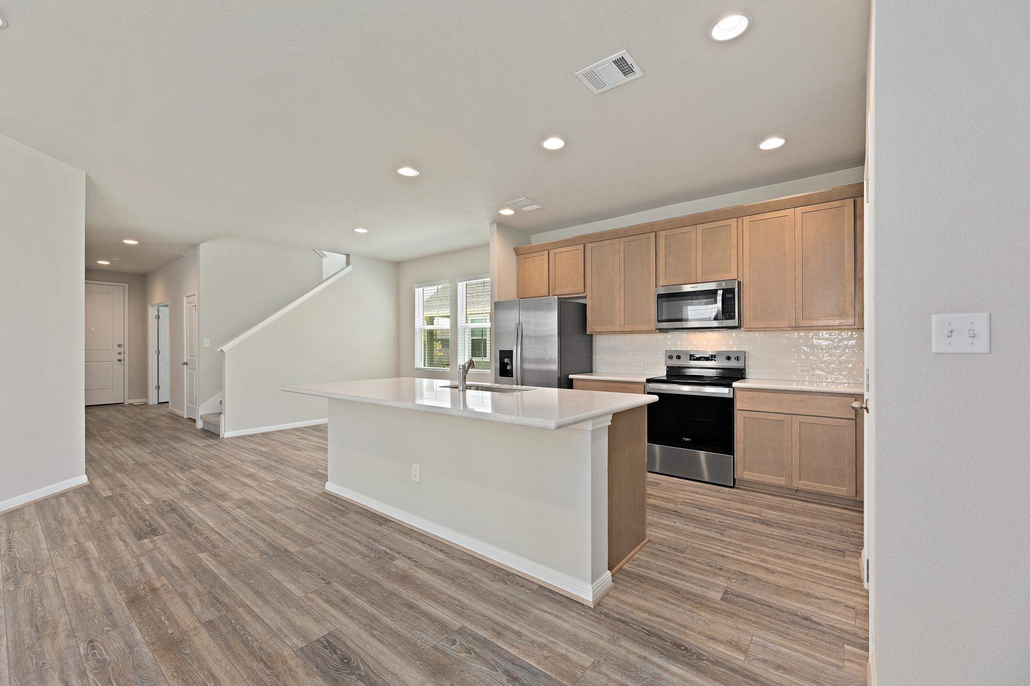 Gleaming wood-look floors anchor this contemporar