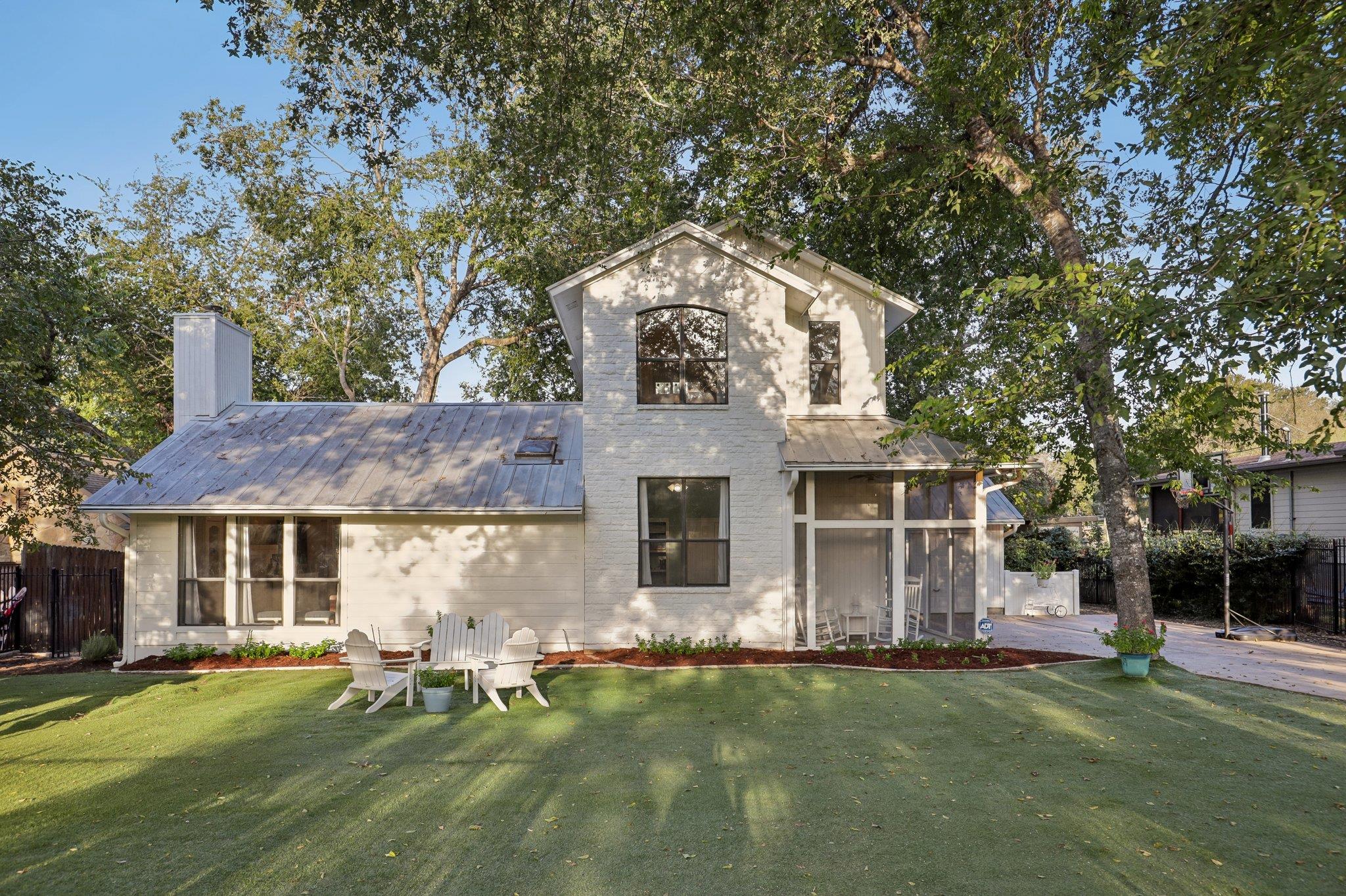 Mature trees shade a charming multi-level brick e