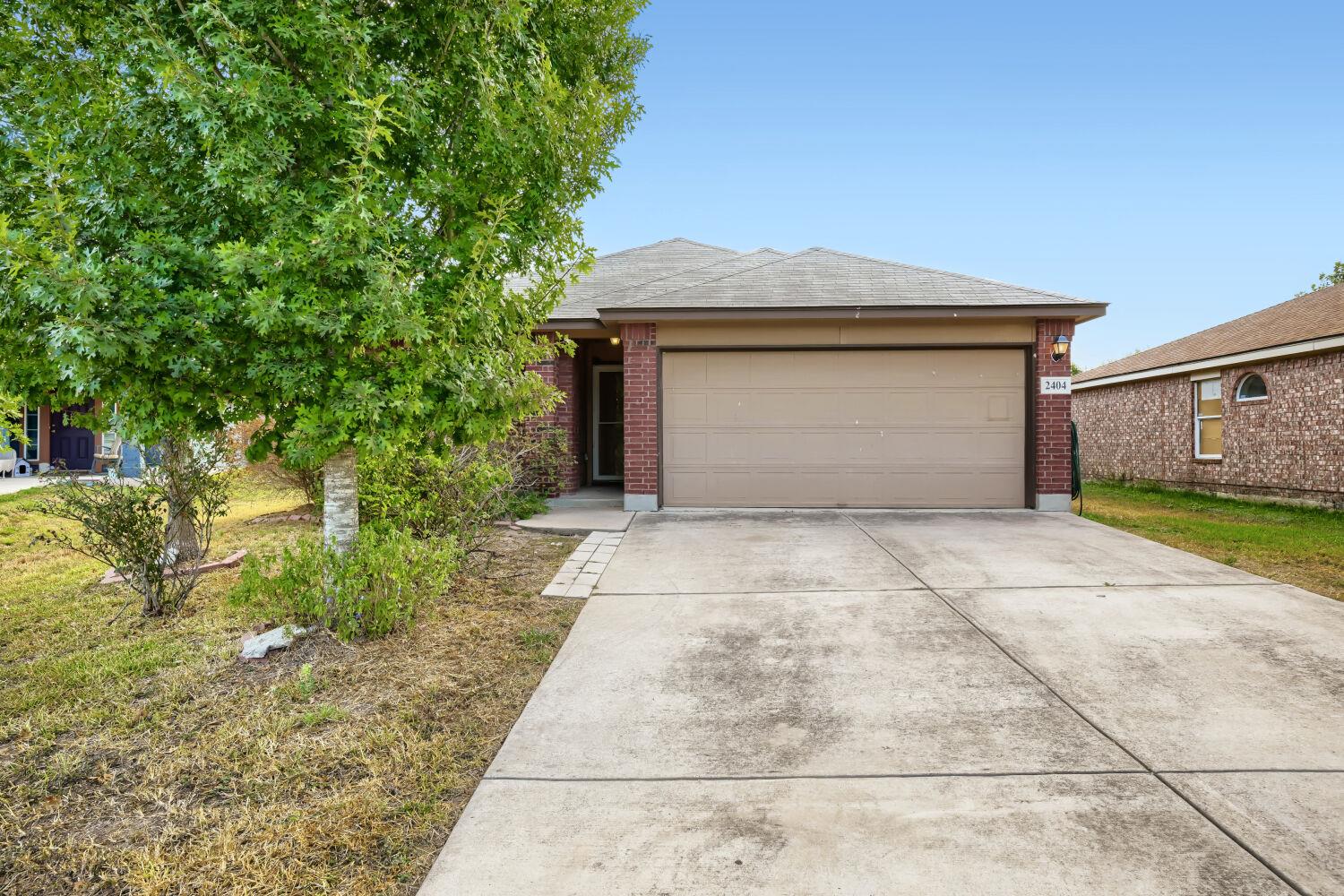 Classic brick exterior features a wide concrete d