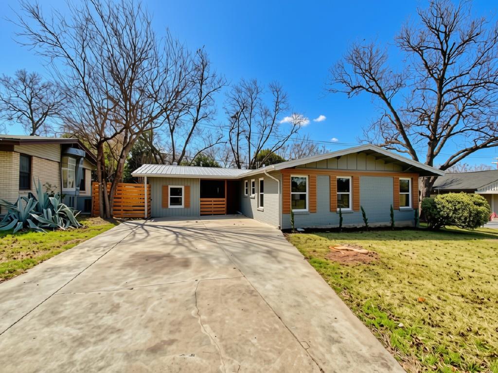 A concrete driveway leads to this single-story ho