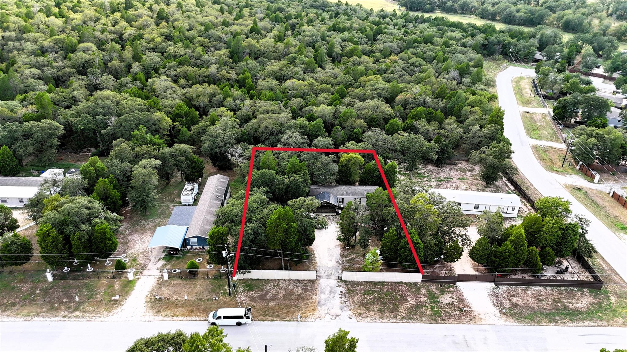 Mature trees surround this private acreage lot ou