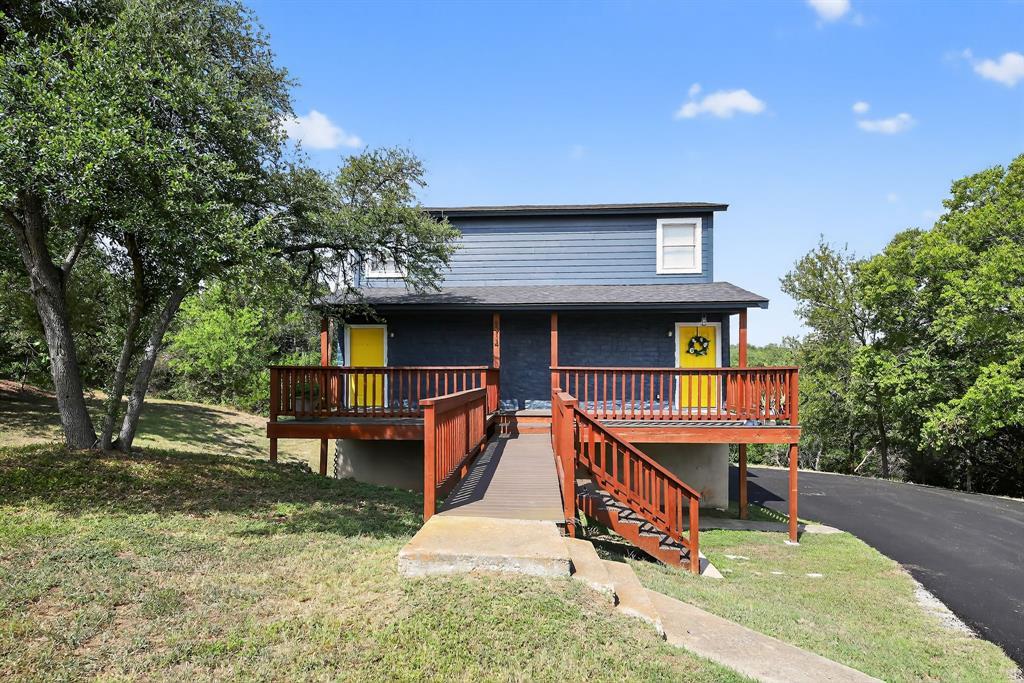 Mature trees frame a raised wooden deck with walk