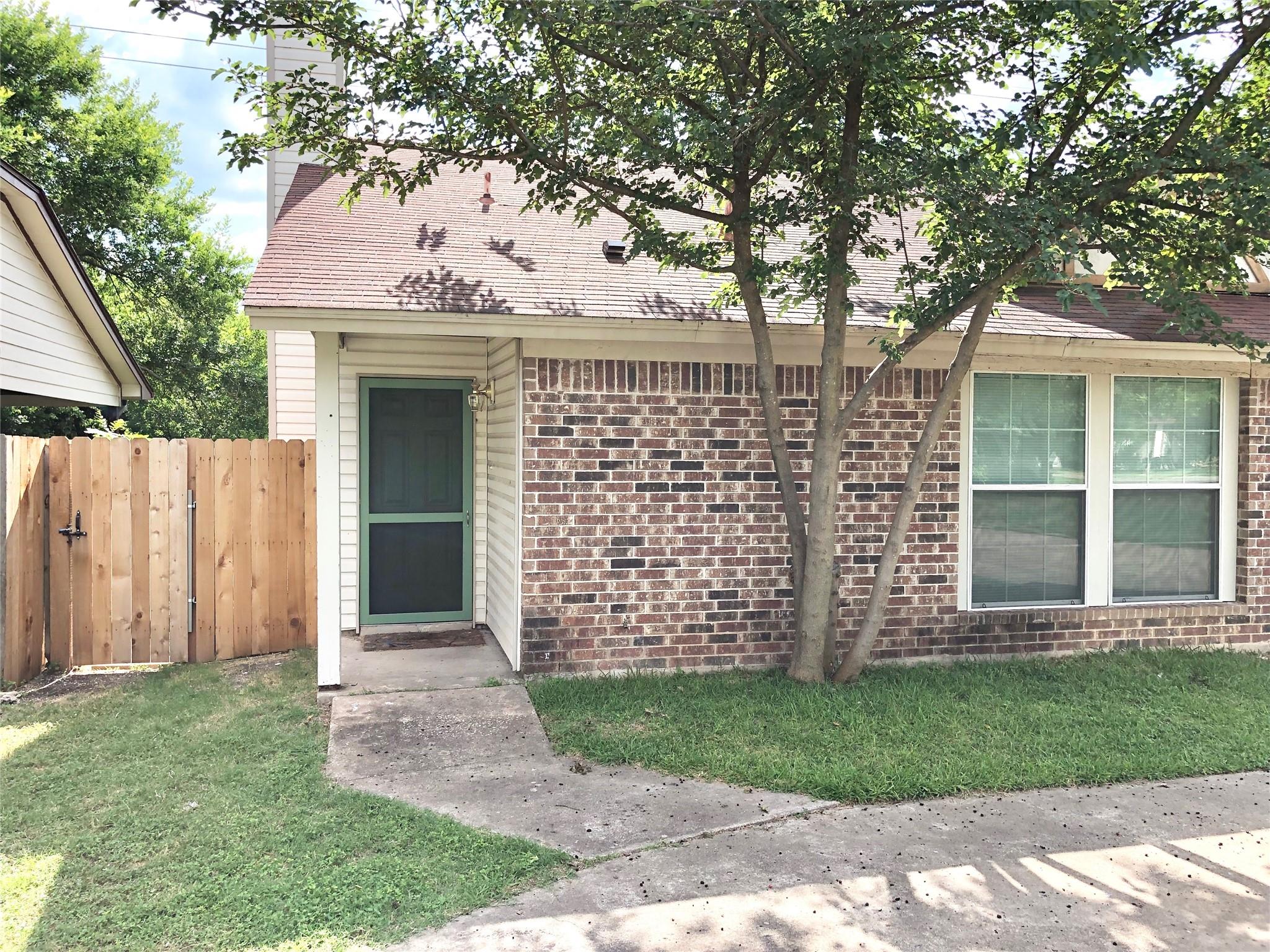 A classic brick exterior features a sheltered ent