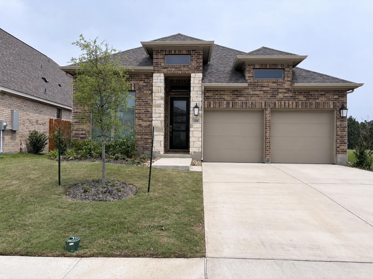 Brick and stone facade residence featuring a two-
