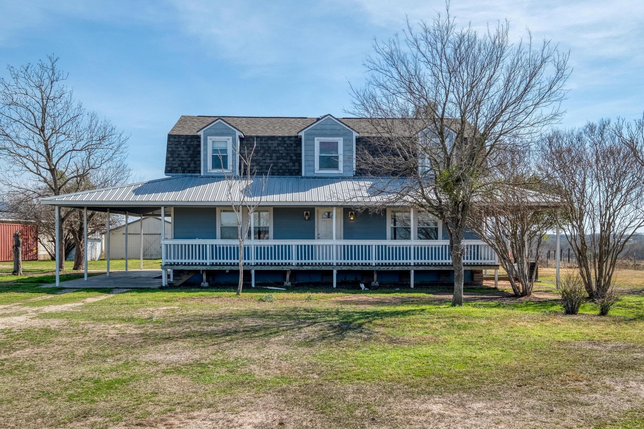An expansive covered porch wraps around this coun