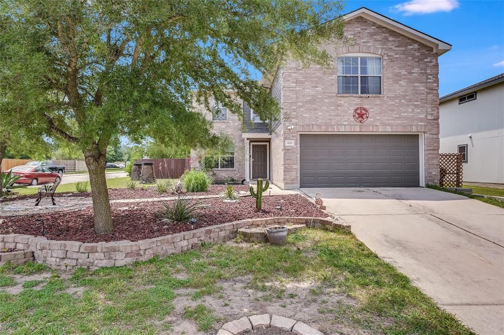 A classic brick exterior and a concrete driveway 
