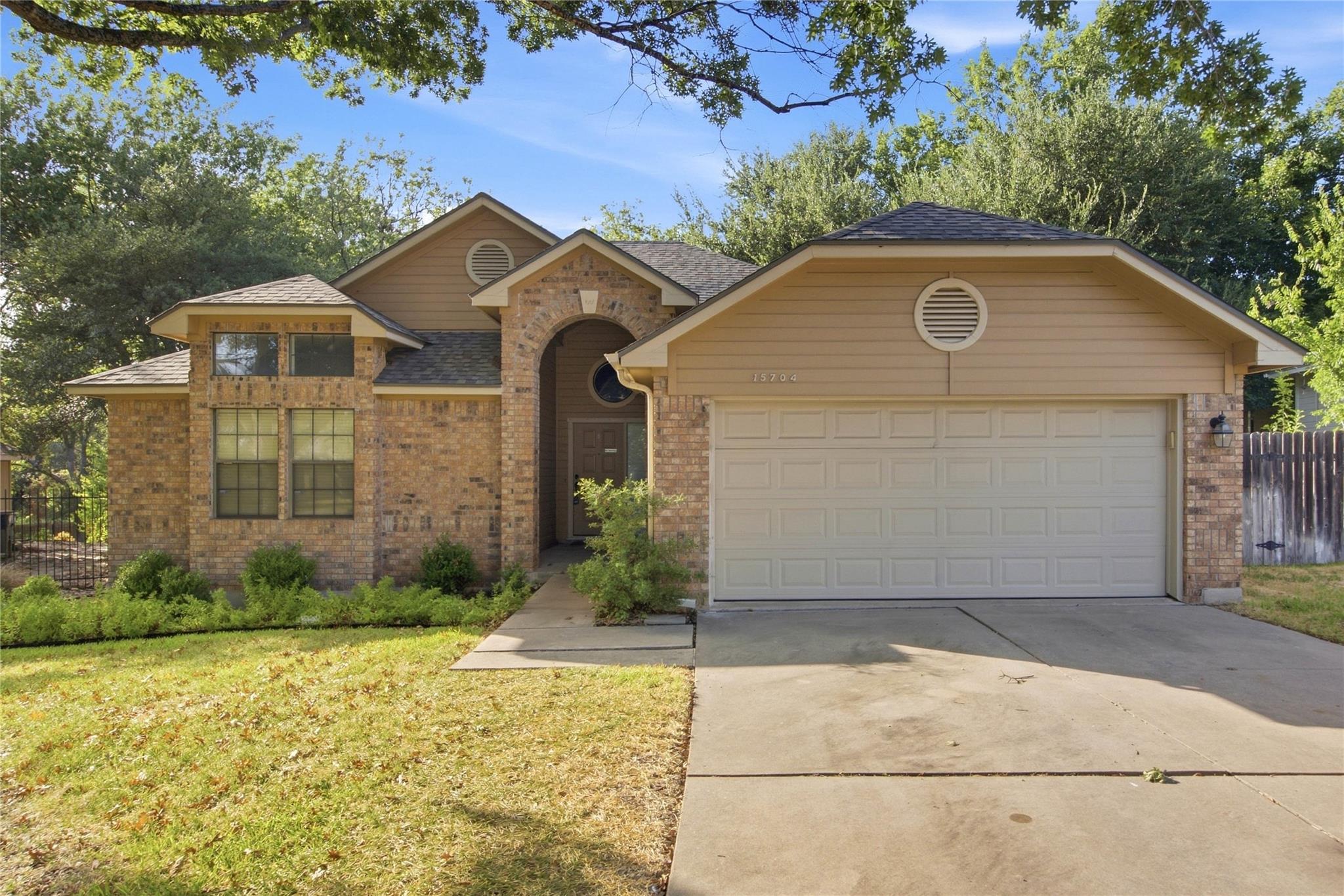 Warm brick and siding accents define the exterior
