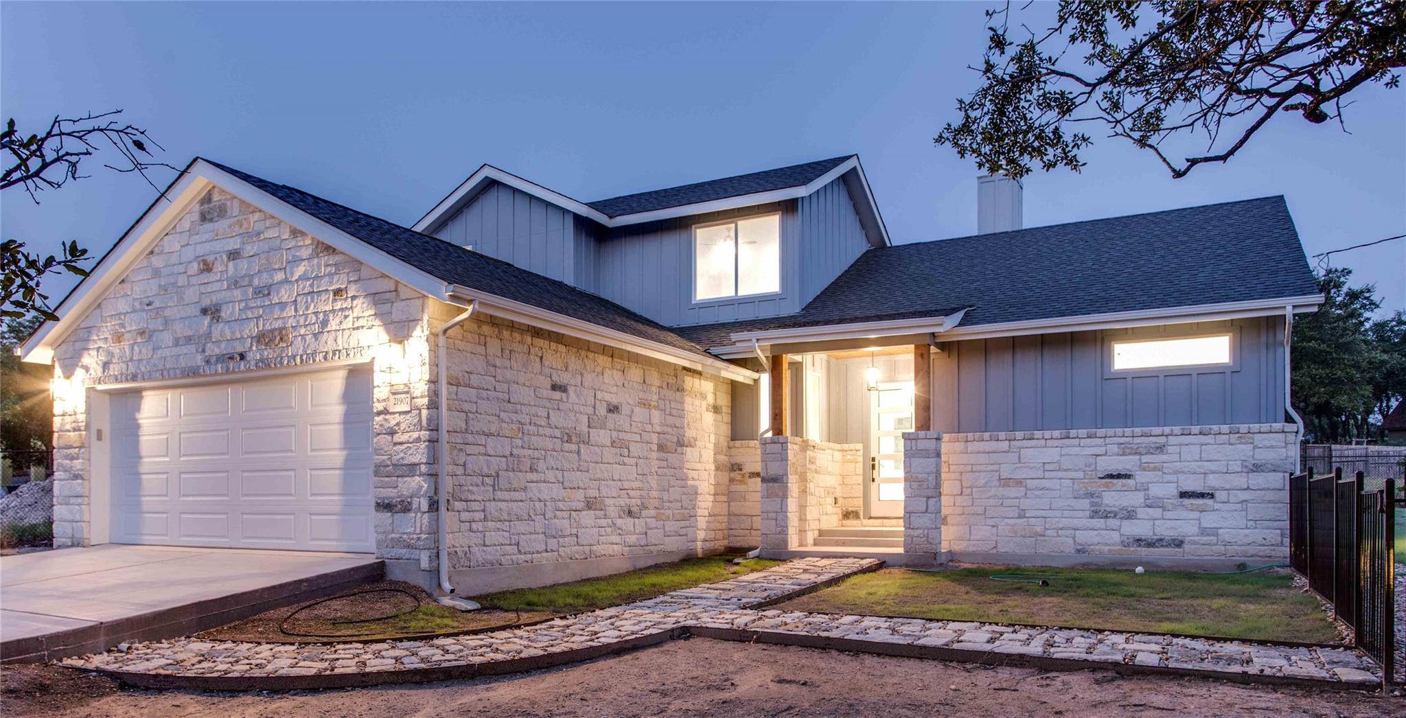 Textured light stone masonry and board-and-batten