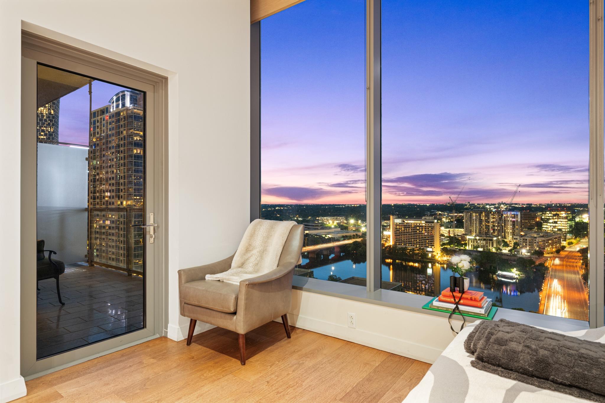 Floor-to-ceiling windows frame sweeping city and 