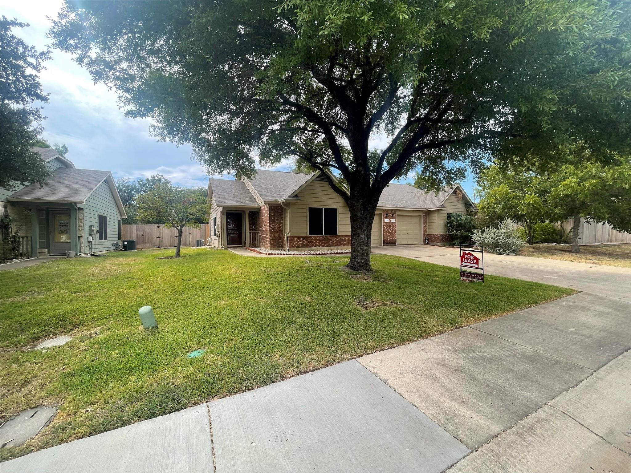 Mature trees shade the manicured lawn of this cha
