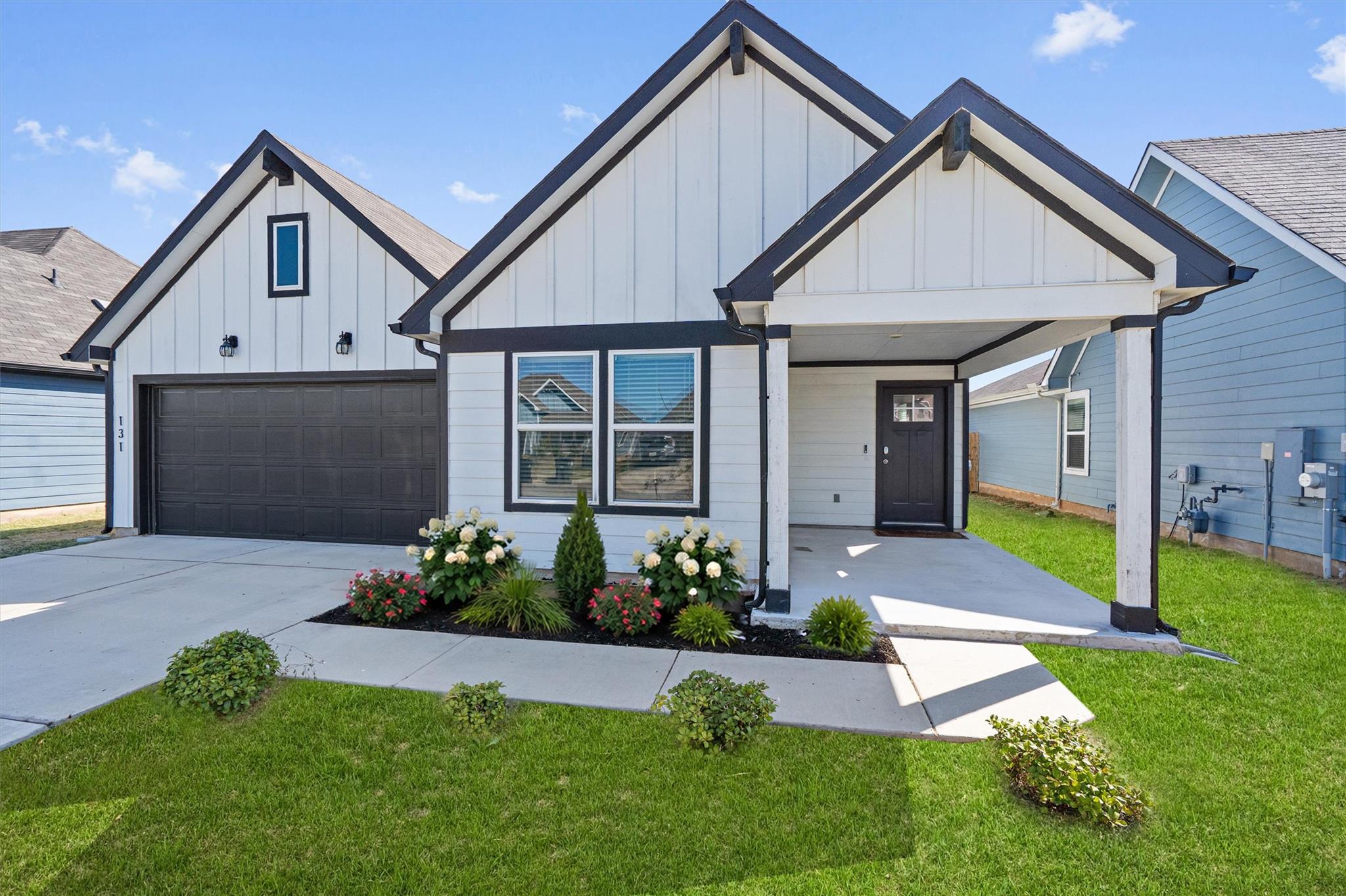 Striking vertical siding and crisp trim frame the