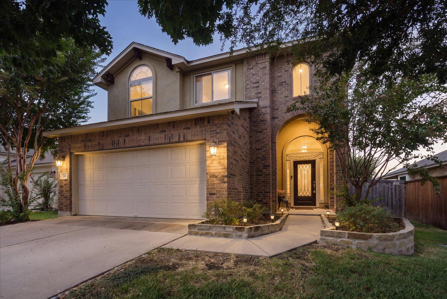 An inviting stone and stucco exterior features an
