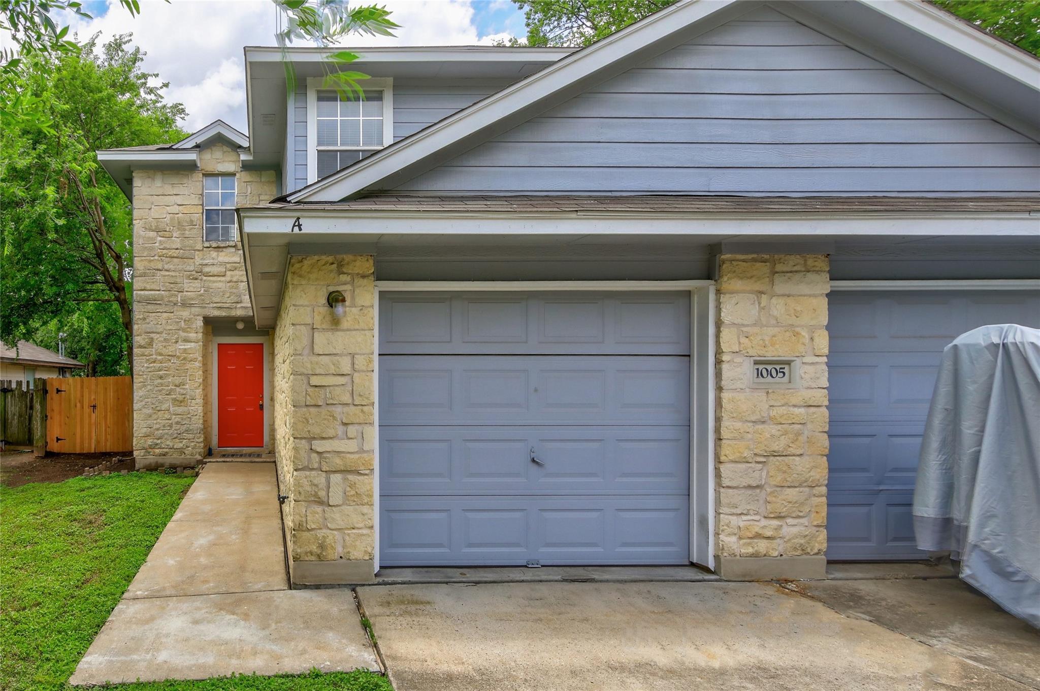 Textured stone veneer accents the exterior facade