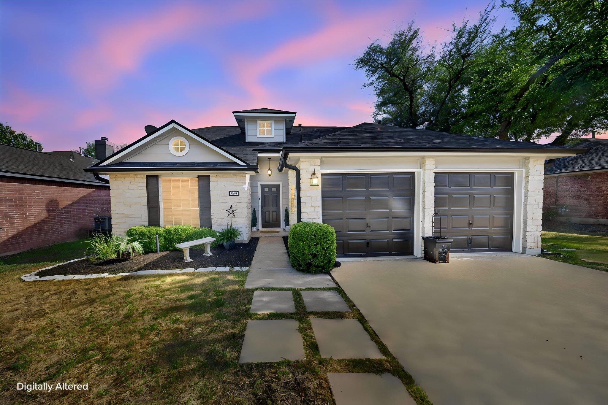 A charming stone accent facade joins two garage b