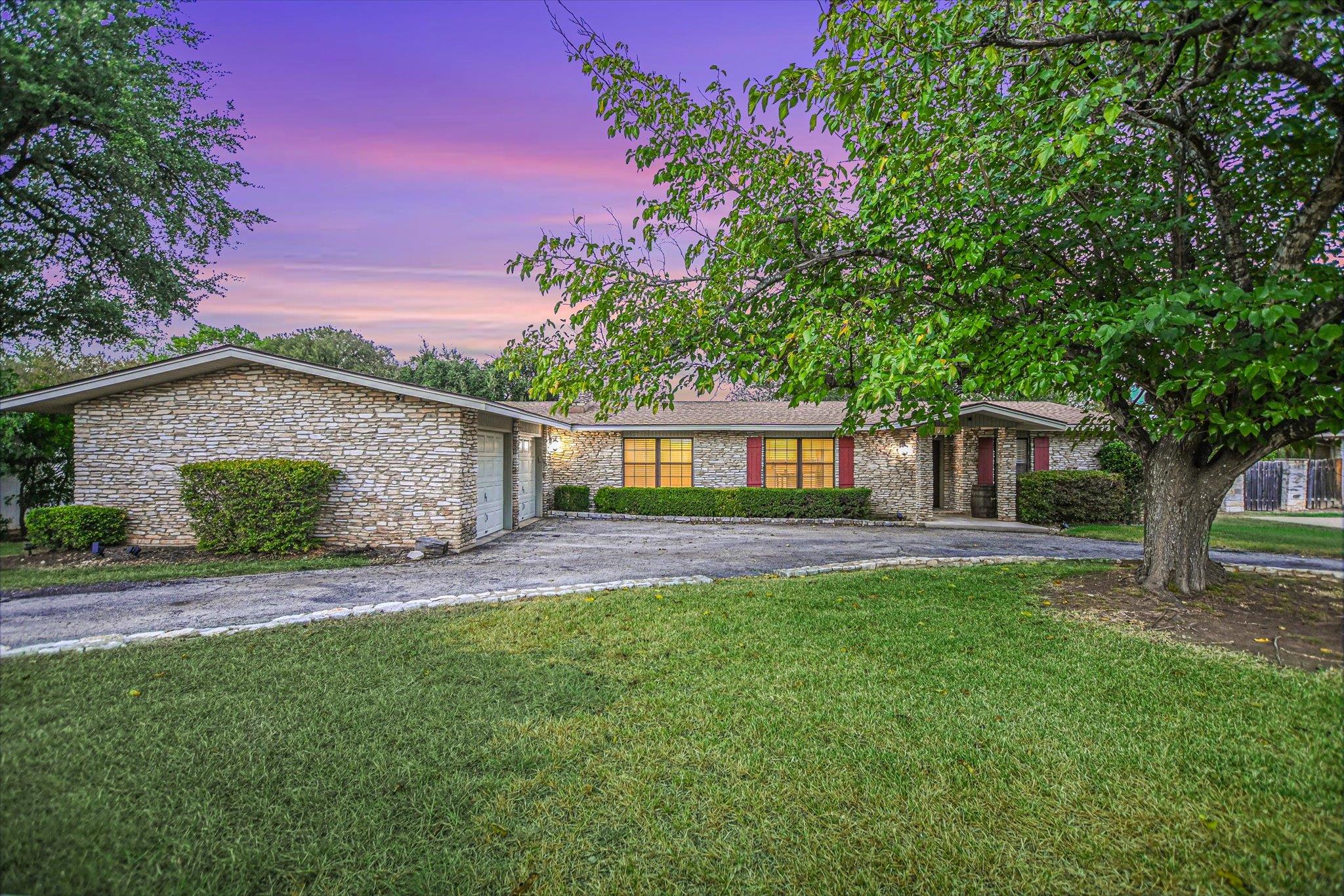 A classic stone exterior defines this ranch-style