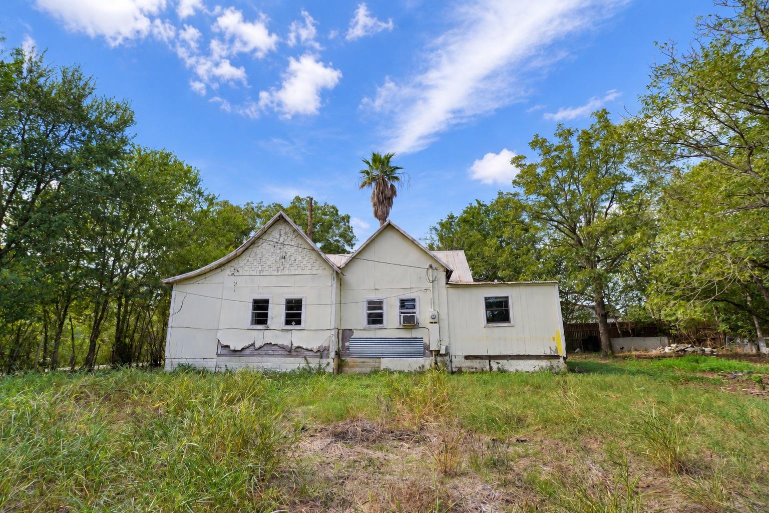 Mature trees surround this classic cottage proper