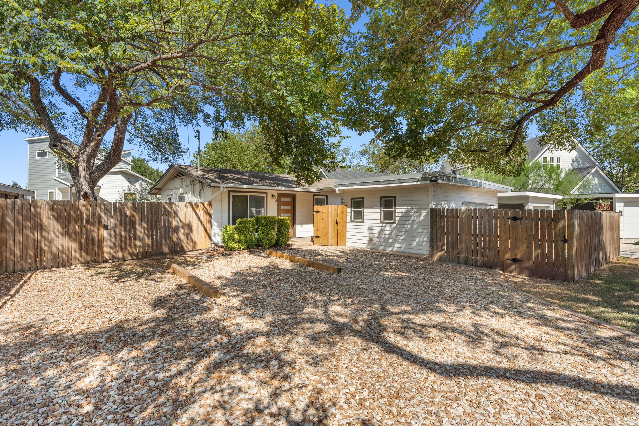 Mature trees shade a charming single-level reside