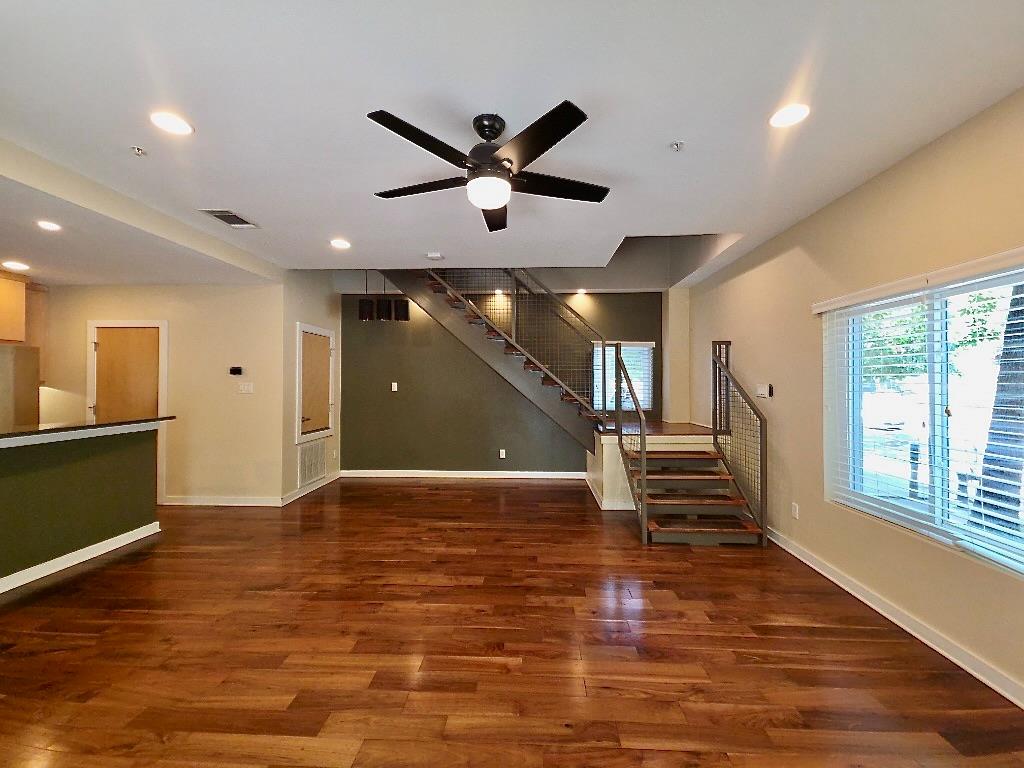 Warm wood flooring grounds this open living space