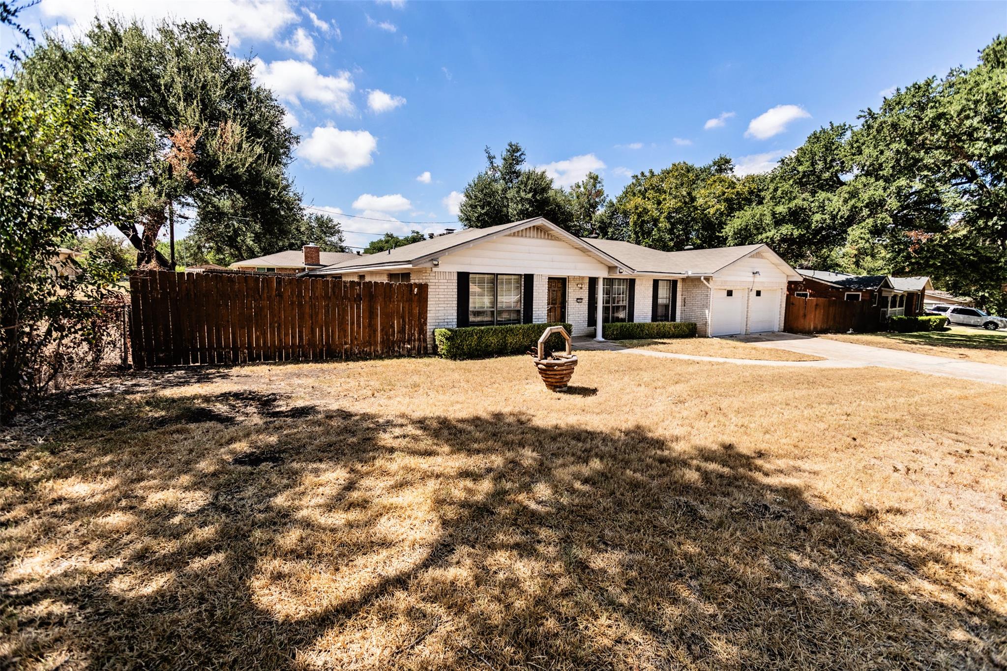 Mature trees shade the spacious front yard of thi
