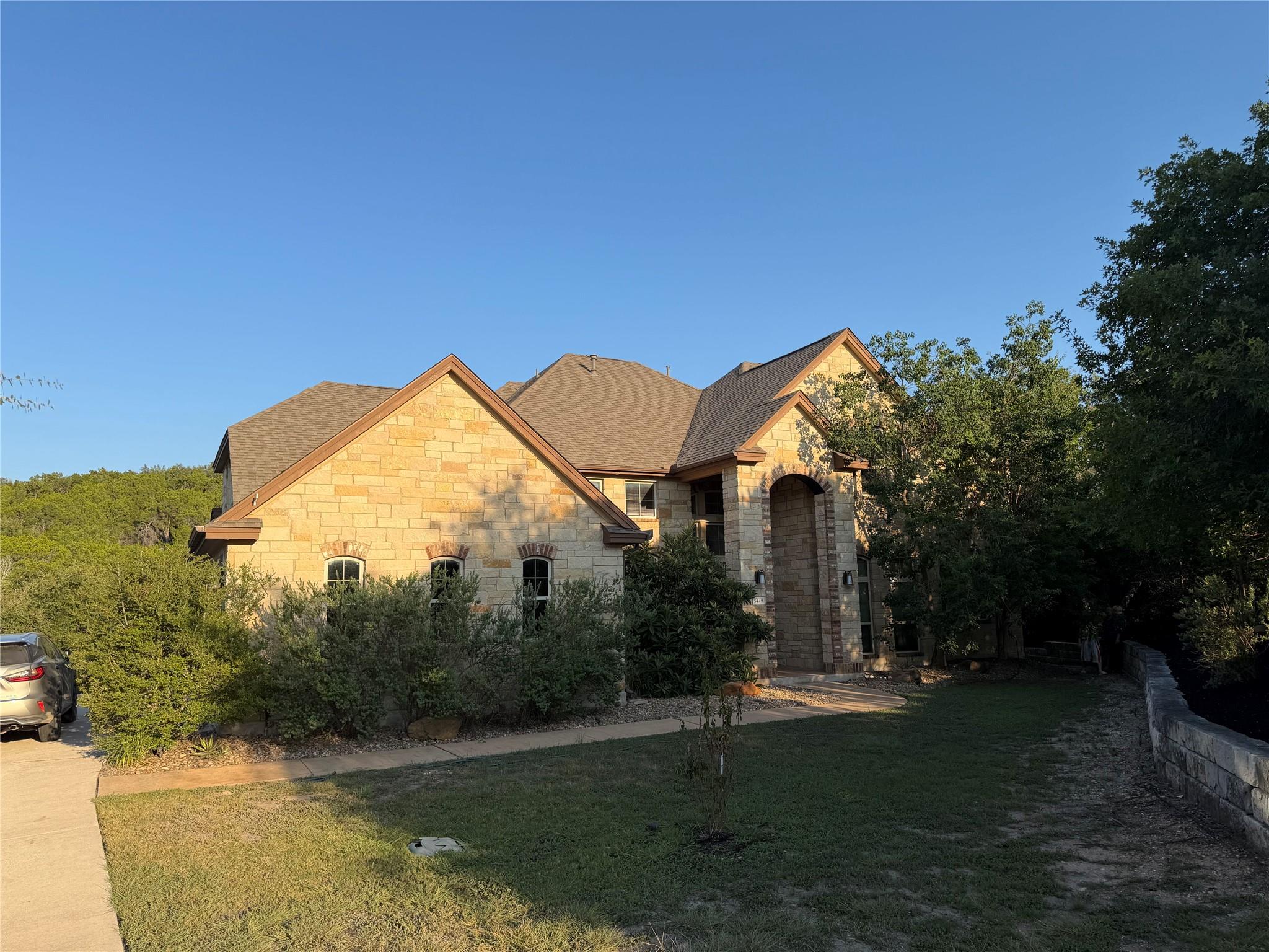 Textured stone siding and multi-gabled rooflines 