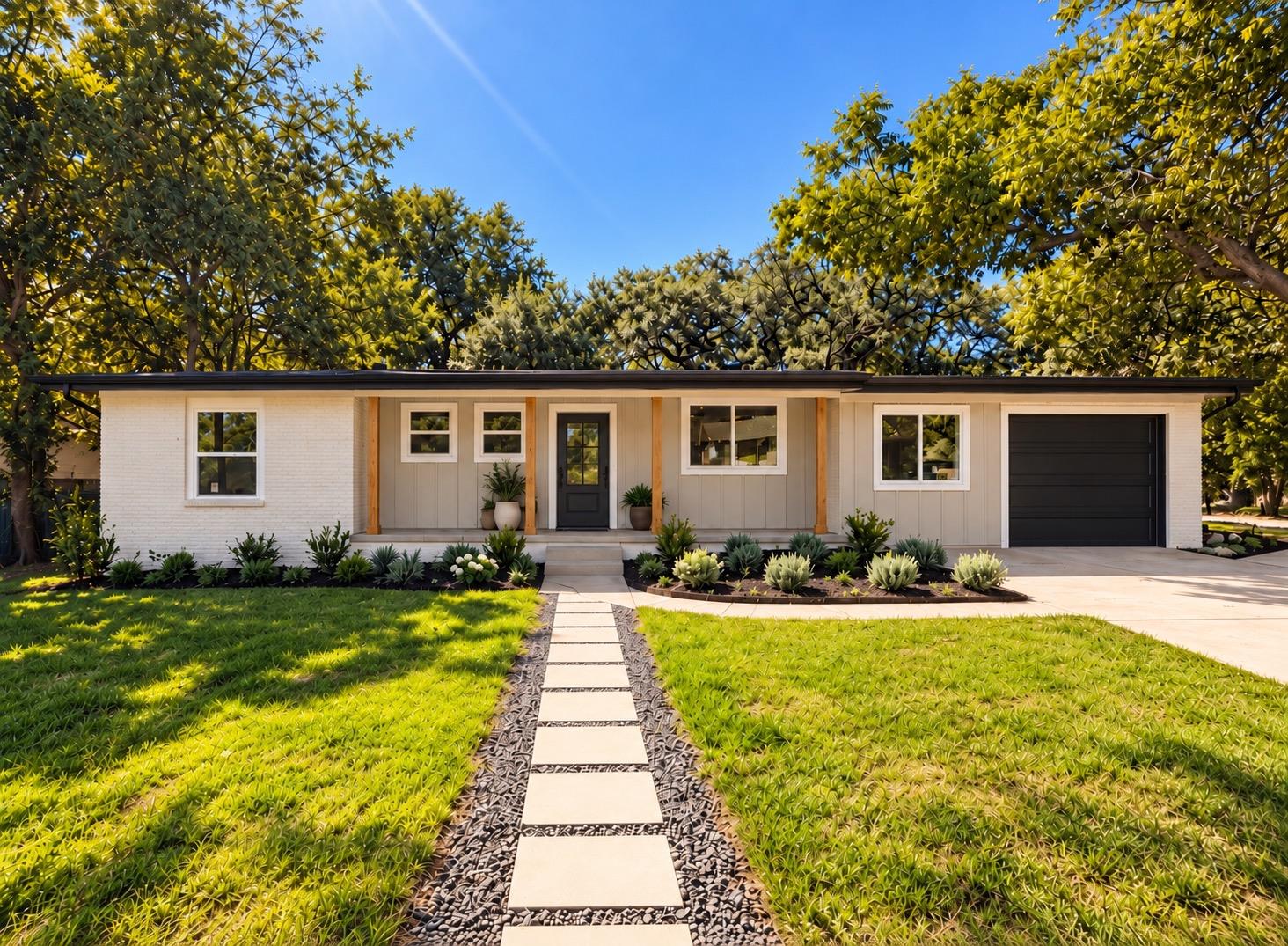 Mature trees frame a charming ranch-style exterio