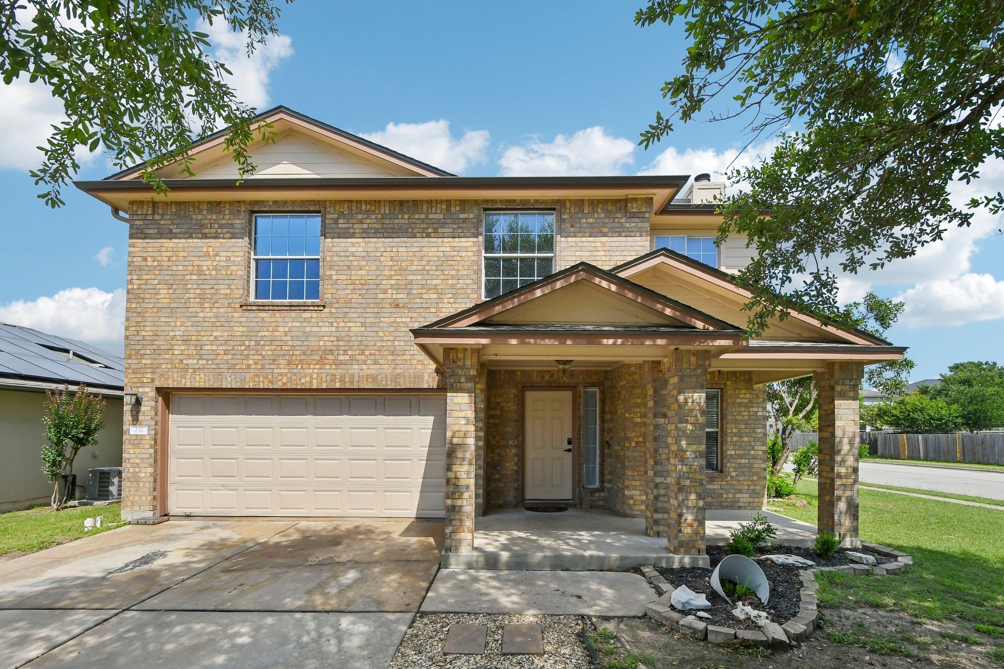 Brick facade with an inviting covered porch entra