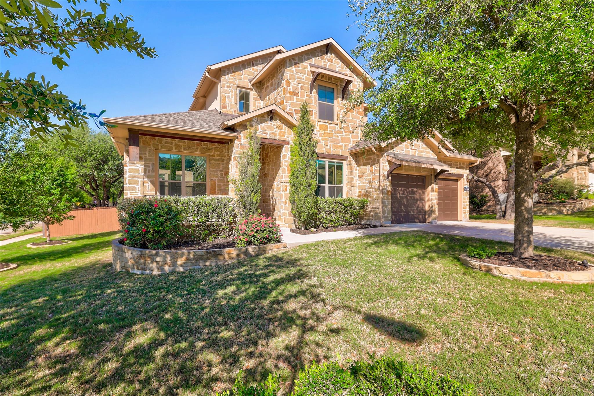Natural stone masonry and manicured landscaping d