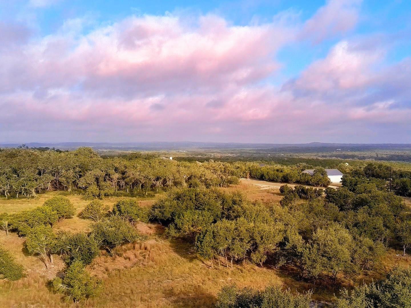 Rolling hills stretch toward the horizon under a 
