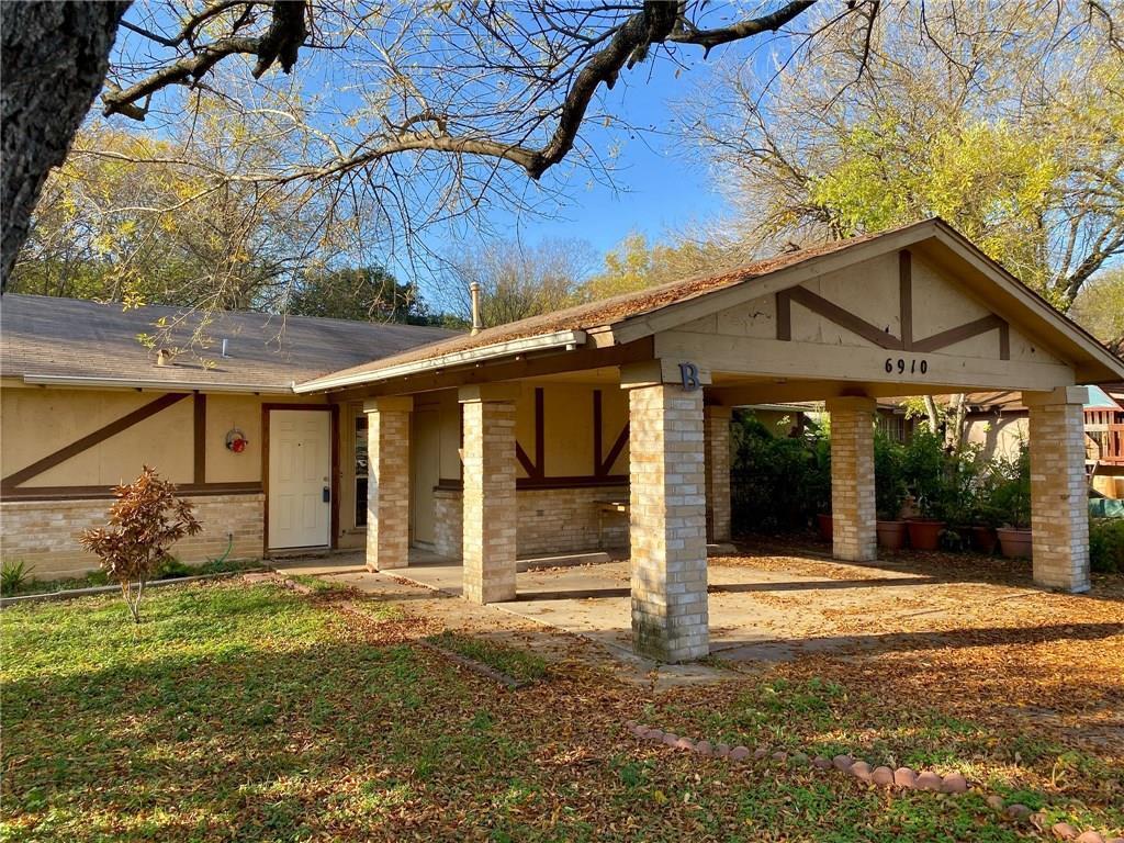 Mature trees shade the front entrance and attache