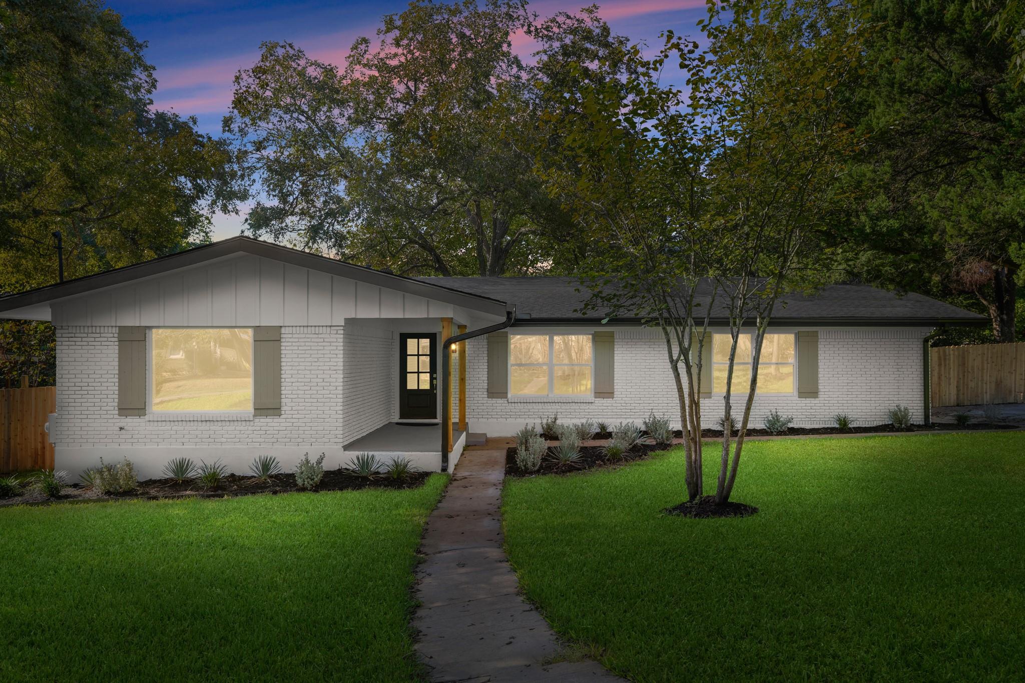 Mature trees frame a charming ranch home with cla