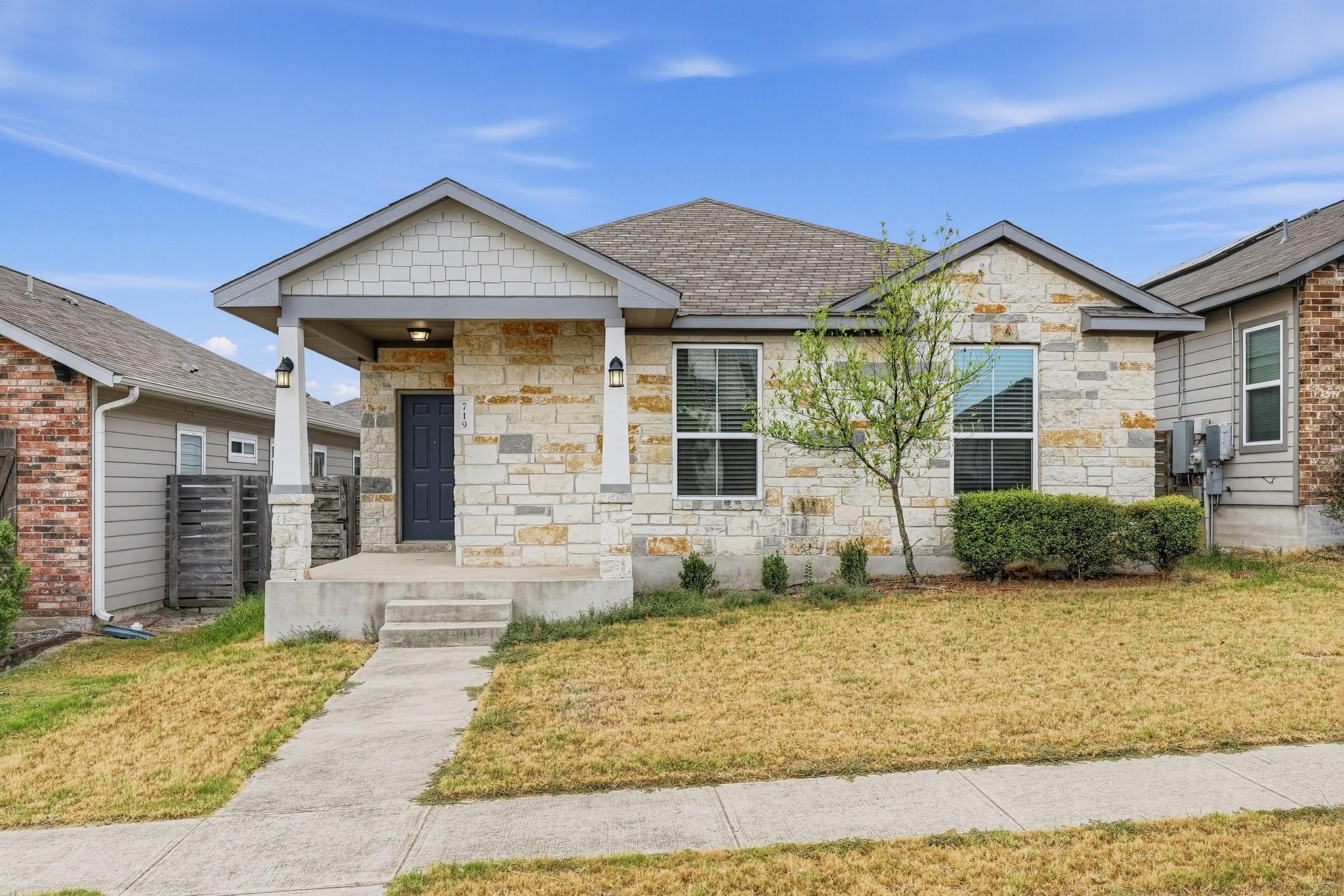 Natural stone masonry and a welcoming front porch