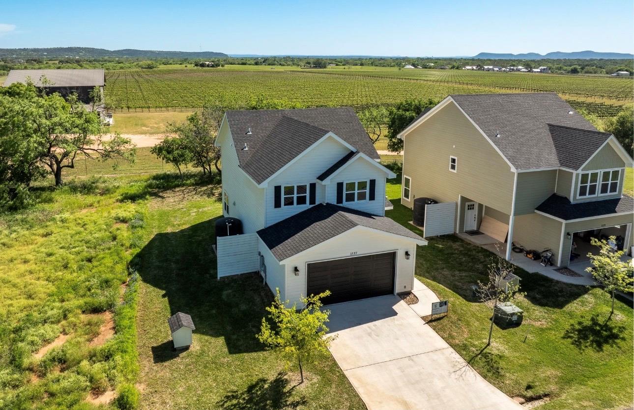 A concrete driveway leads to the attached front g
