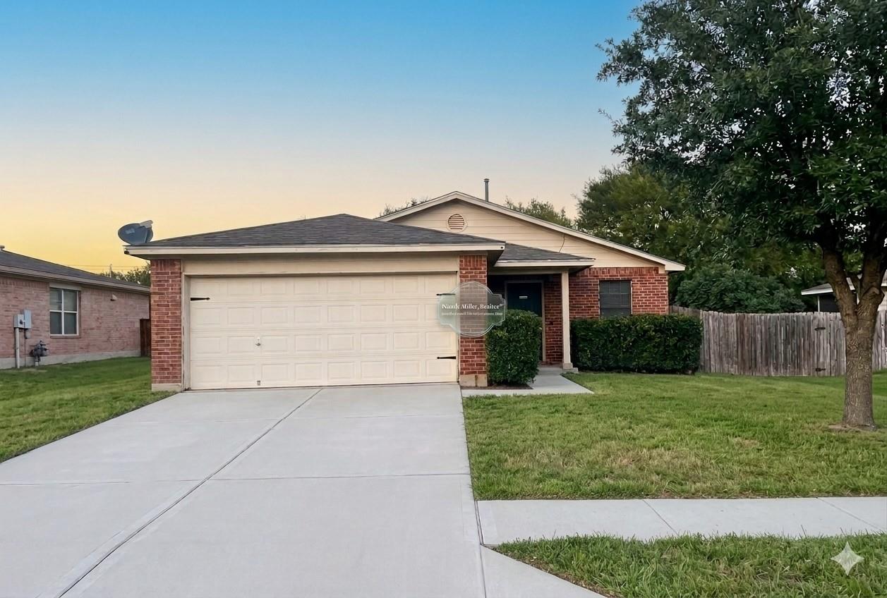A spacious driveway and concrete path lead to a c