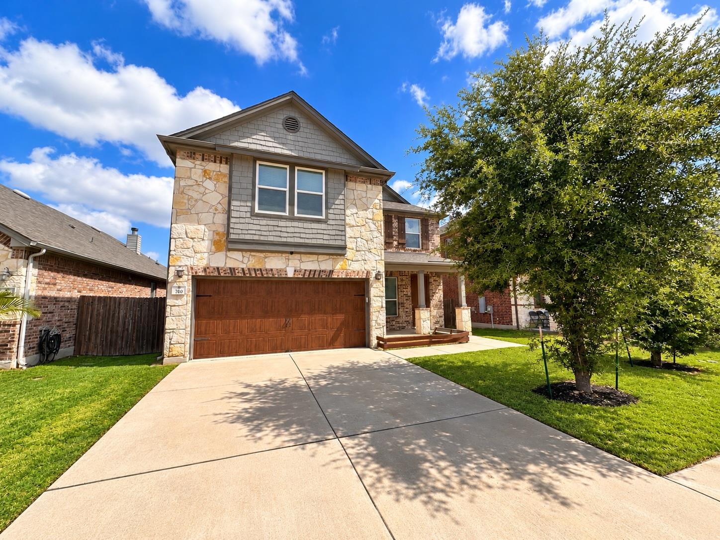 An inviting stone and siding exterior displays a 