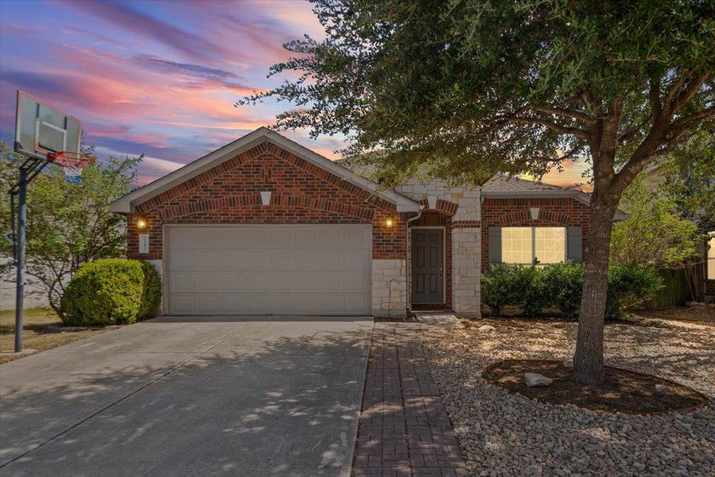 A classic brick exterior and concrete driveway de