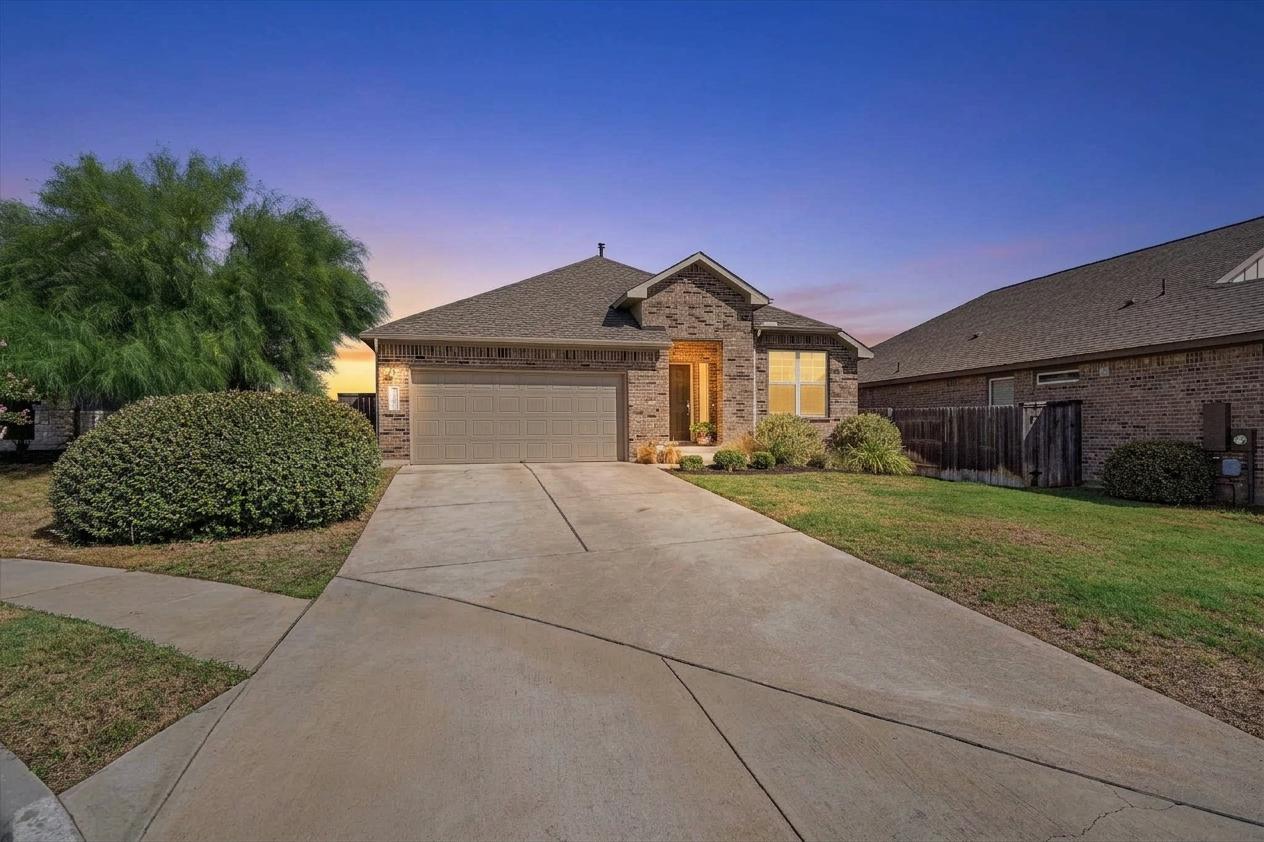 A spacious concrete driveway leads to a classic b