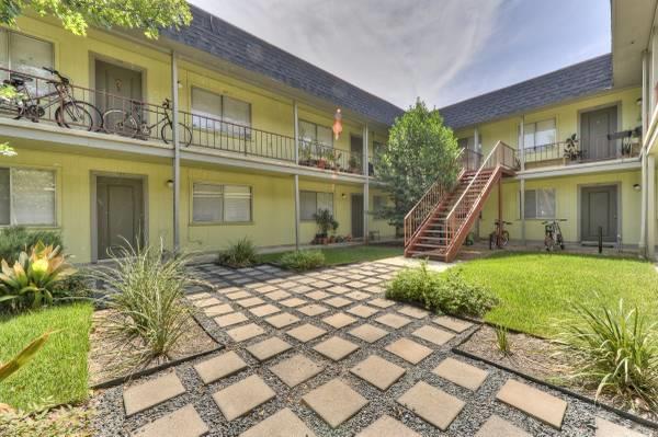 A central courtyard features a paved walkway and 