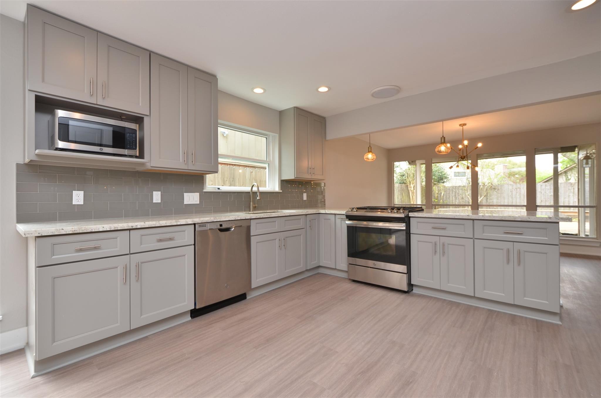 Streamlined cabinetry and modern appliances defin