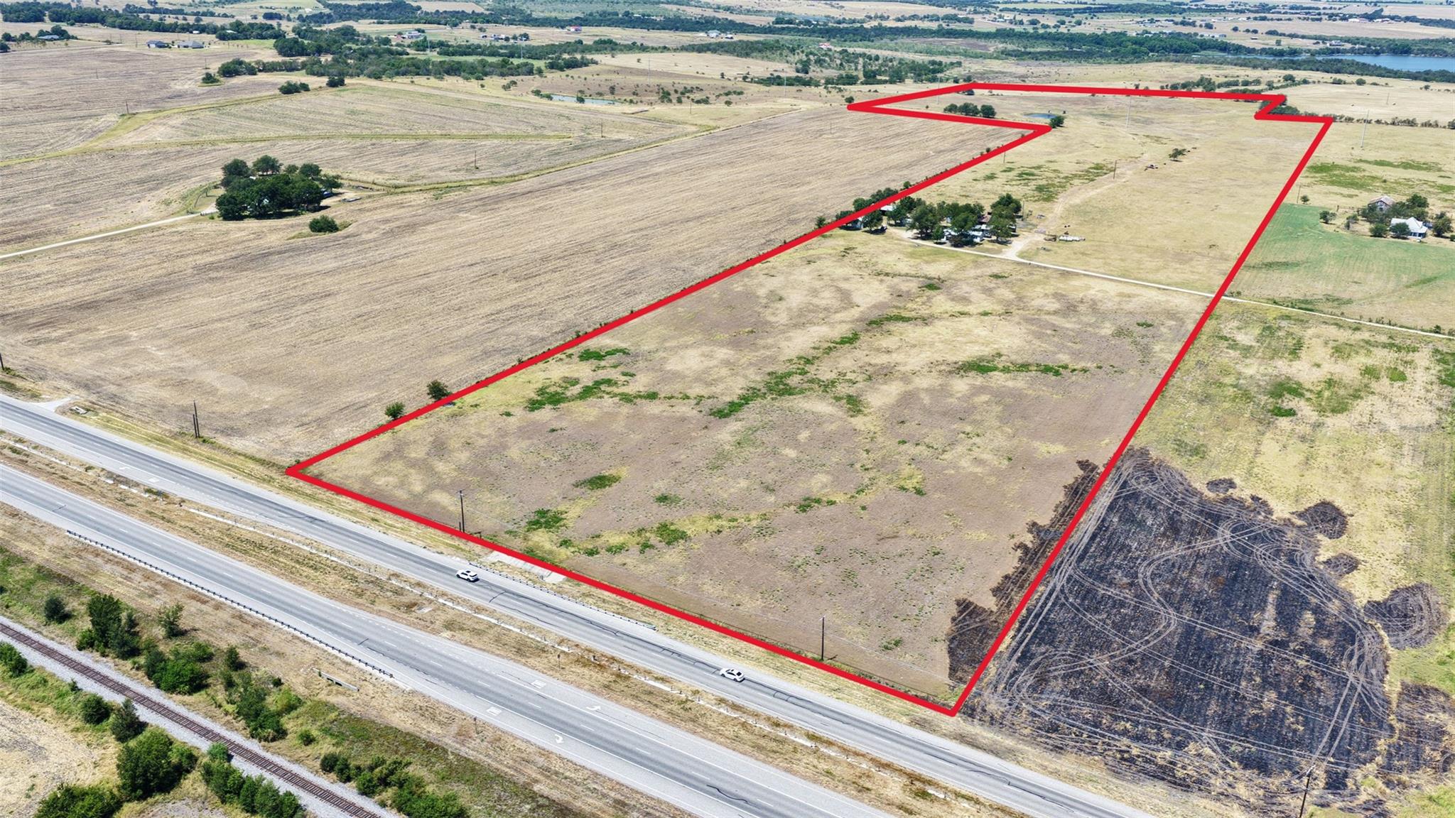 Vast acreage outlined in red borders a major road