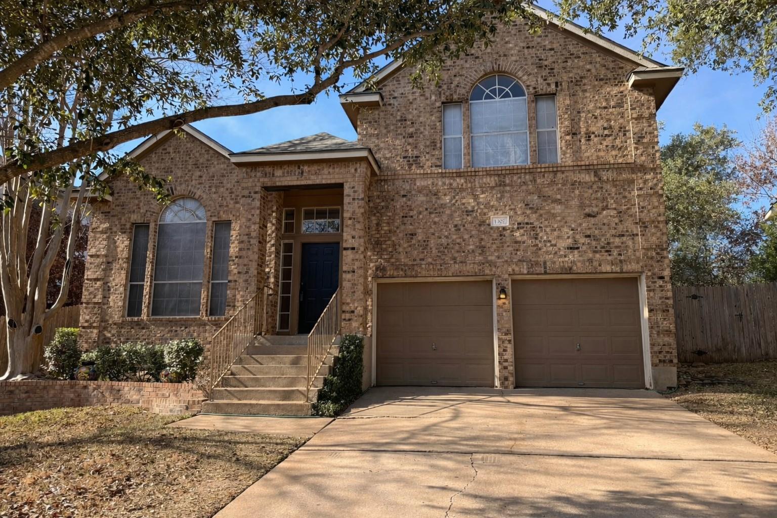 Traditional-style house with brick siding, concre