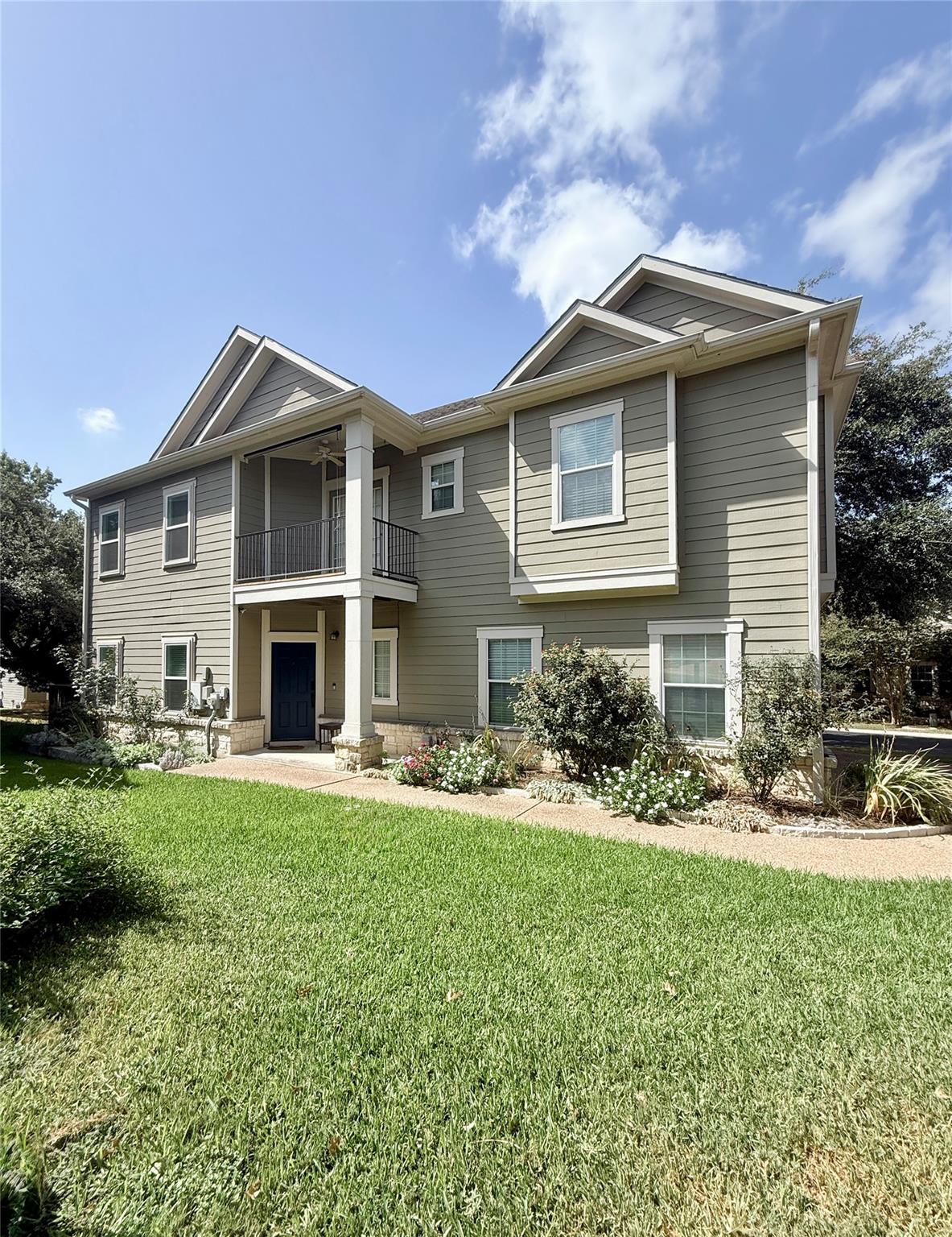 A classic two-story facade showcases neat siding,