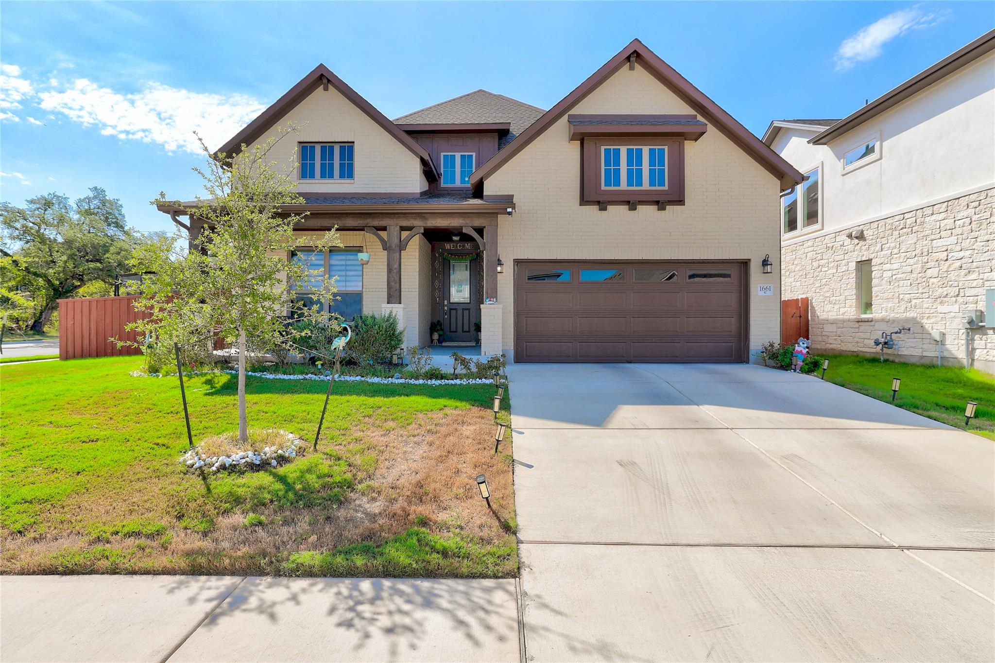 Charming gabled rooflines and a concrete driveway