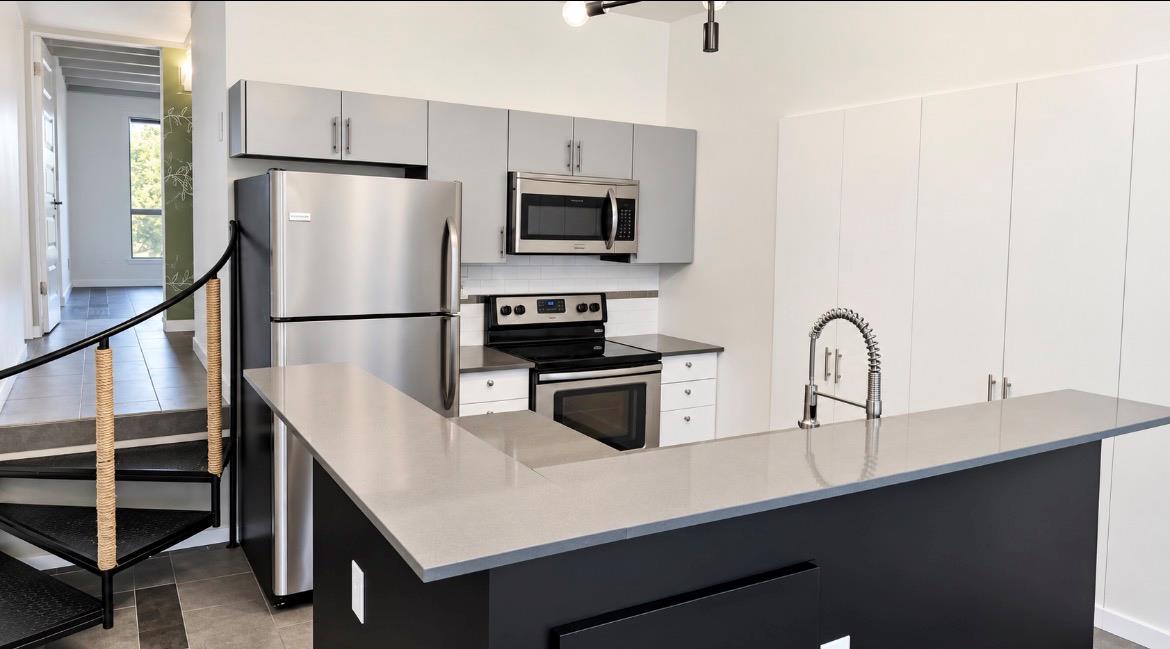 Sleek modern countertops and stainless steel appl